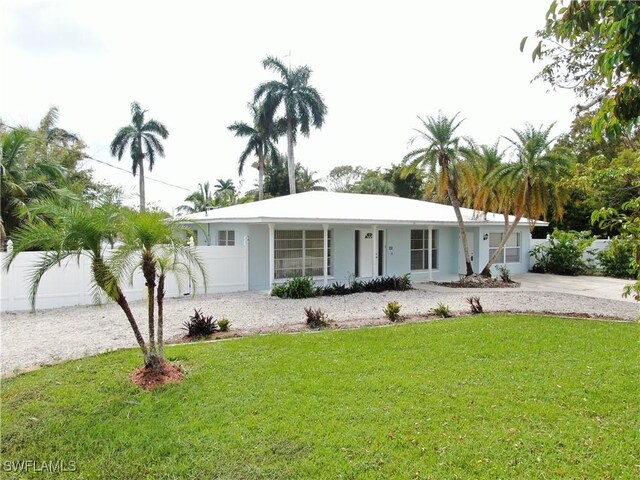 22 Constitution Dr, Naples, FL 34112 - single story home featuring stucco siding, a front lawn, concrete driveway, and fence