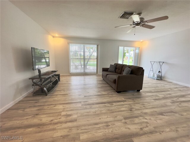 living room with ceiling fan and light hardwood / wood-style floors