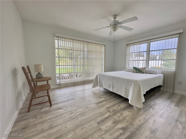 bedroom with ceiling fan and hardwood / wood-style flooring