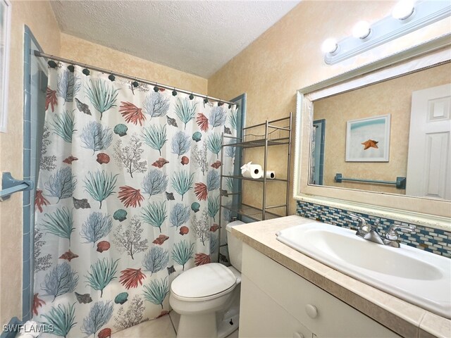 bathroom featuring vanity, backsplash, toilet, a textured ceiling, and walk in shower