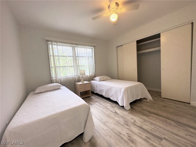 bedroom with ceiling fan, a closet, and hardwood / wood-style flooring