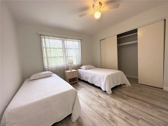 22 Constitution Dr, Naples, FL 34112 - bedroom with wood finished floors, a closet, a ceiling fan, and baseboards