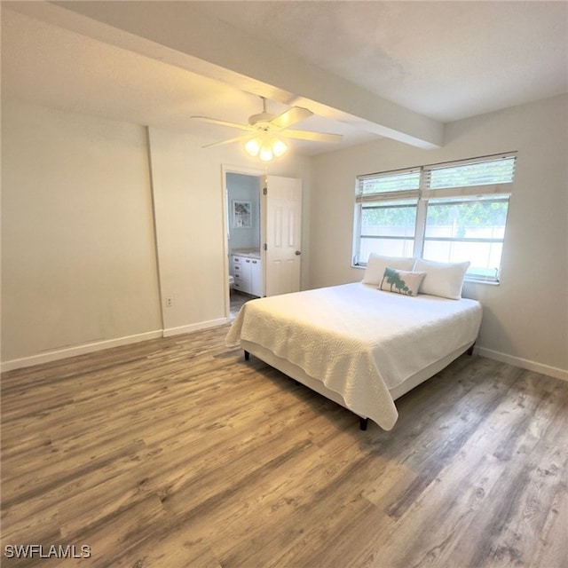 bedroom featuring beamed ceiling, wood-type flooring, ensuite bath, and ceiling fan