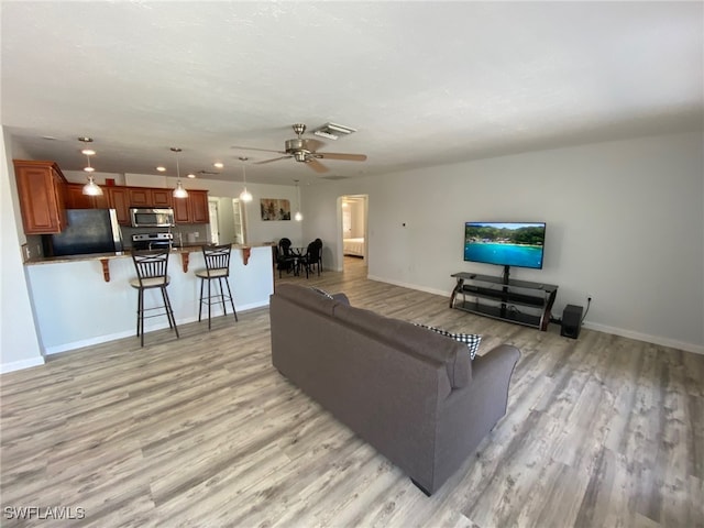 22 Constitution Dr, Naples, FL 34112 - living room with light wood-type flooring, visible vents, a ceiling fan, and baseboards