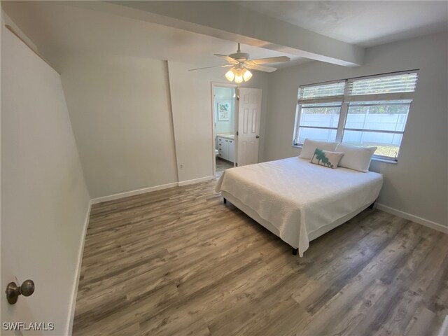 22 Constitution Dr, Naples, FL 34112 - bedroom featuring wood finished floors, ceiling fan, beamed ceiling, baseboards, and ensuite bath