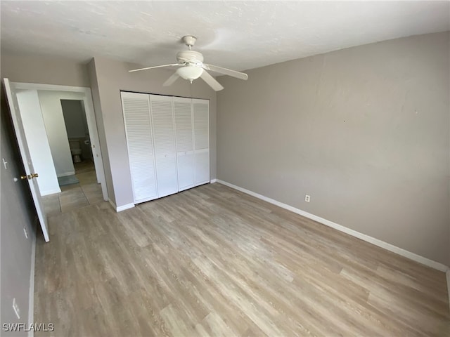 22 Constitution Dr, Naples, FL 34112 - unfurnished bedroom with light wood finished floors, baseboards, and a closet