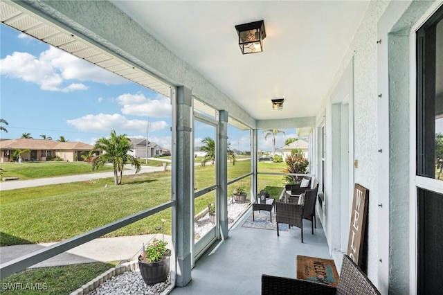 sunroom featuring a residential view