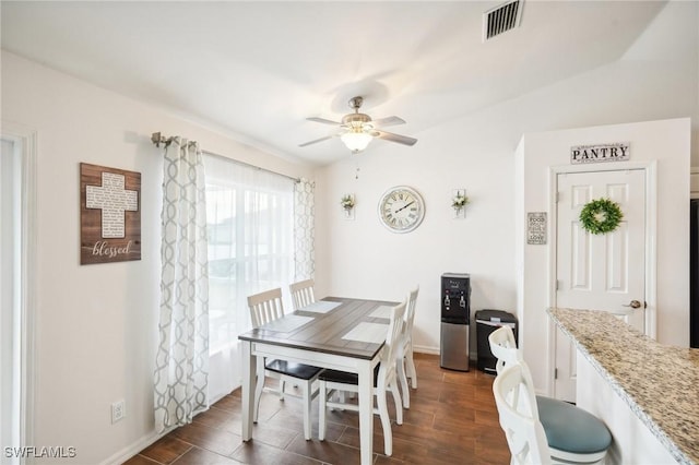 dining area featuring visible vents, baseboards, dark wood-style floors, and ceiling fan