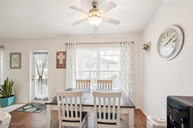 dining room featuring wood finished floors, baseboards, and ceiling fan