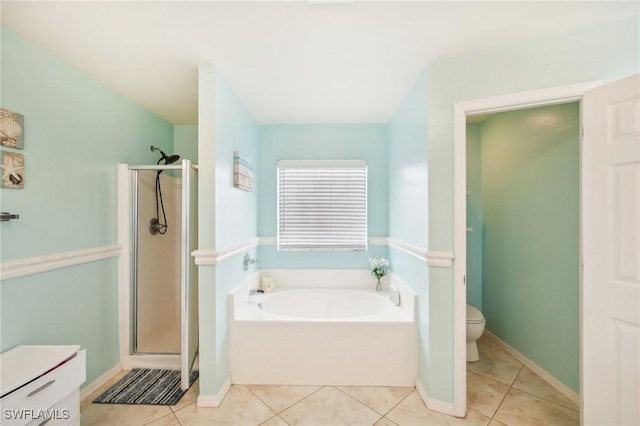 bathroom featuring tile patterned floors, a garden tub, a stall shower, and toilet