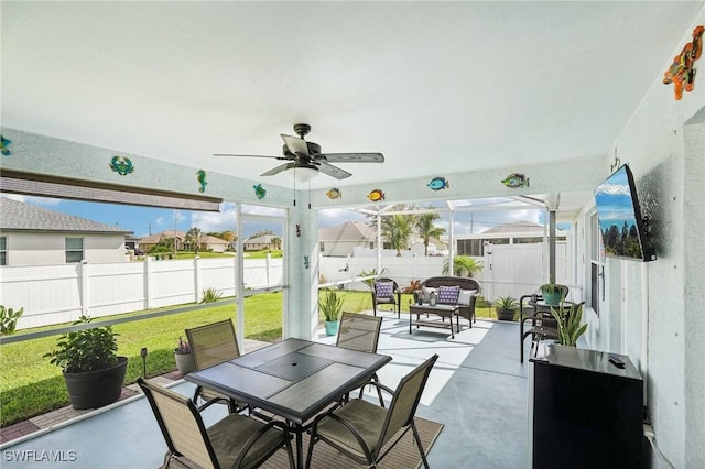 view of patio / terrace featuring outdoor dining area, a fenced backyard, and a ceiling fan