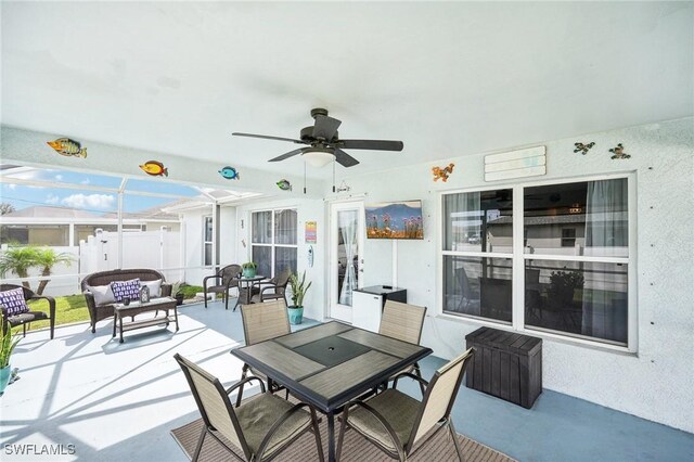 view of patio / terrace with outdoor dining space, outdoor lounge area, a ceiling fan, and fence