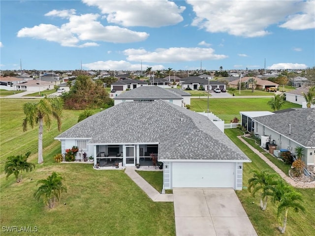 view of front of property with a front lawn, a residential view, concrete driveway, roof with shingles, and an attached garage