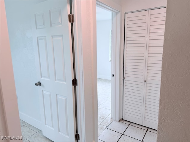 corridor featuring light tile patterned floors