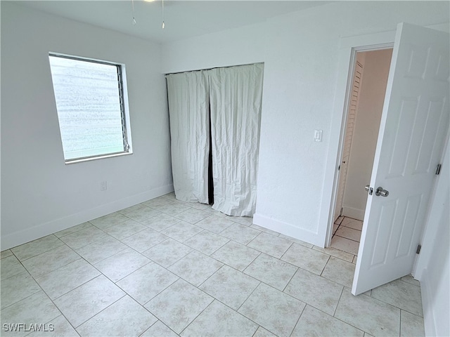 unfurnished bedroom with light tile patterned floors