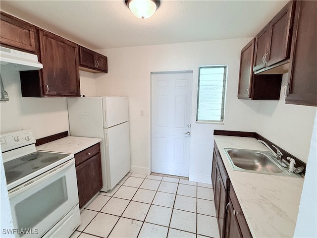 kitchen featuring dark brown cabinets, sink, white appliances, and light tile patterned floors