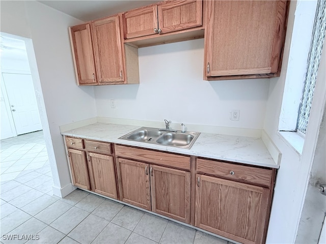 kitchen featuring sink and light tile patterned floors