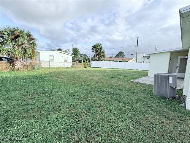 view of yard with cooling unit and a patio