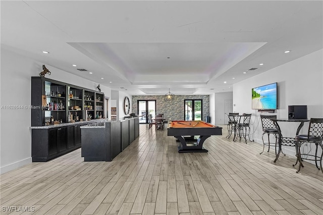 playroom with light wood-type flooring, a tray ceiling, french doors, and billiards