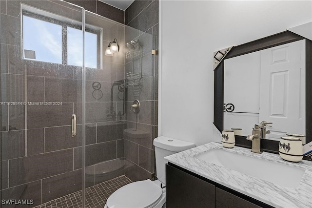 bathroom featuring walk in shower, vanity, and toilet