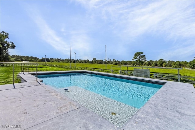 view of swimming pool with a lawn