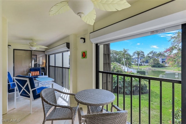 sunroom / solarium featuring a water view, ceiling fan, and plenty of natural light