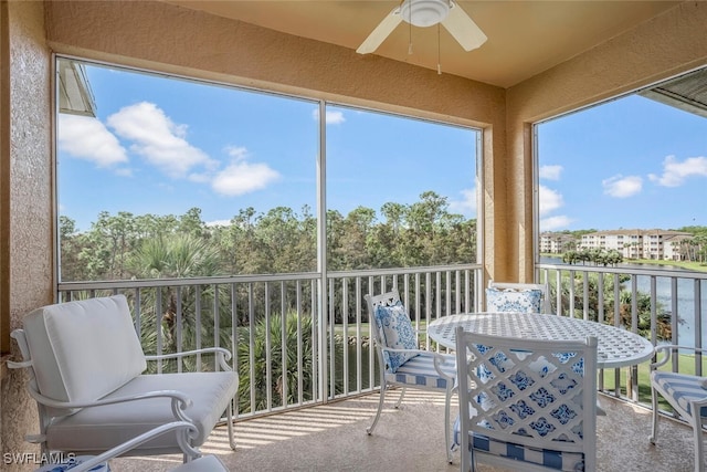 sunroom / solarium featuring ceiling fan