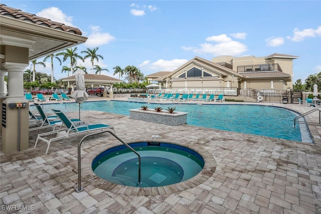 view of swimming pool with a patio and a hot tub