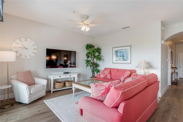 living room featuring hardwood / wood-style flooring and ceiling fan