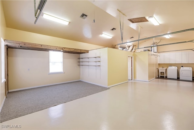 garage featuring washer and clothes dryer and sink