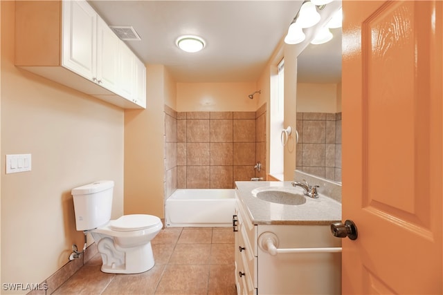 full bathroom featuring tile patterned floors, vanity, toilet, and tiled shower / bath combo