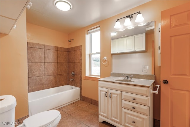 full bathroom with tile patterned flooring, vanity, toilet, and tiled shower / bath combo