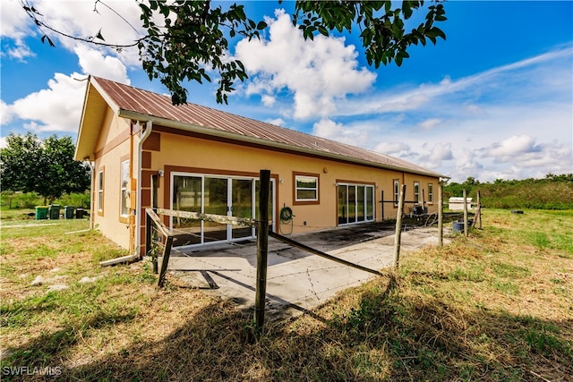 back of property featuring a patio area