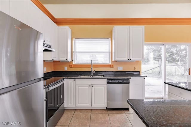 kitchen with stainless steel appliances, white cabinetry, and sink