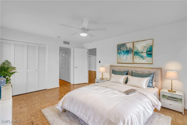 bedroom with light parquet flooring and ceiling fan