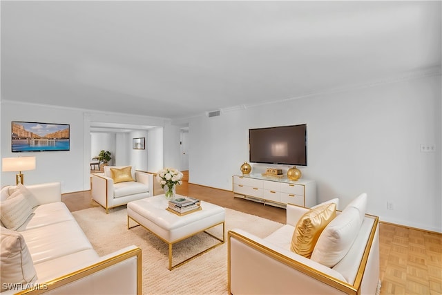 living room featuring light parquet flooring and ornamental molding