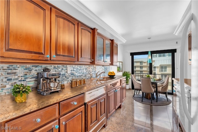 kitchen with tasteful backsplash, sink, decorative light fixtures, light stone counters, and ornamental molding