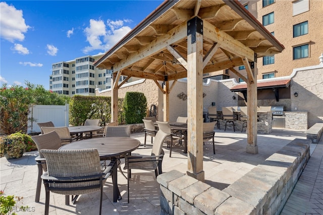 view of patio with a gazebo, exterior kitchen, and area for grilling