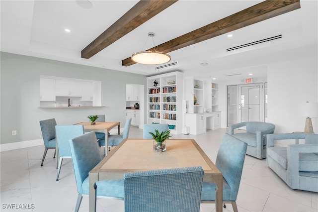 dining room with beamed ceiling and built in shelves