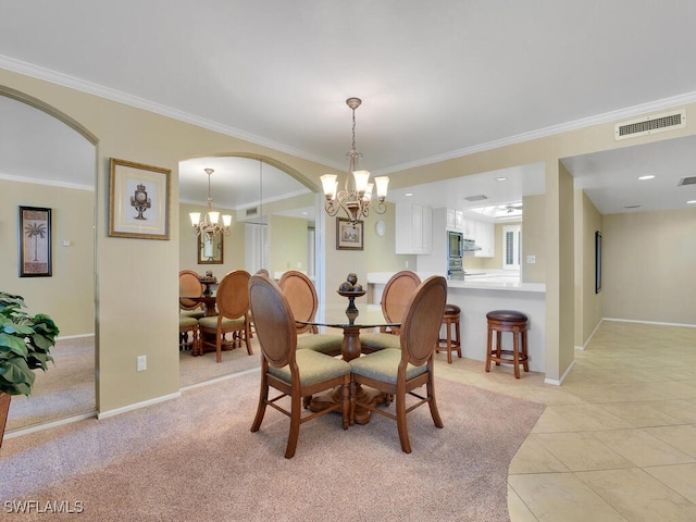 carpeted dining space with ornamental molding and a chandelier