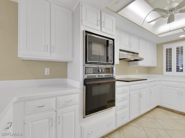 kitchen featuring black appliances, white cabinetry, ceiling fan, and light tile patterned floors