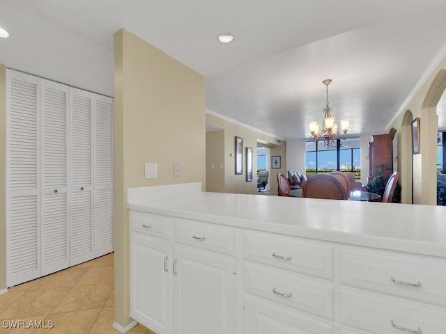 kitchen with a chandelier, white cabinetry, decorative light fixtures, and light tile patterned floors