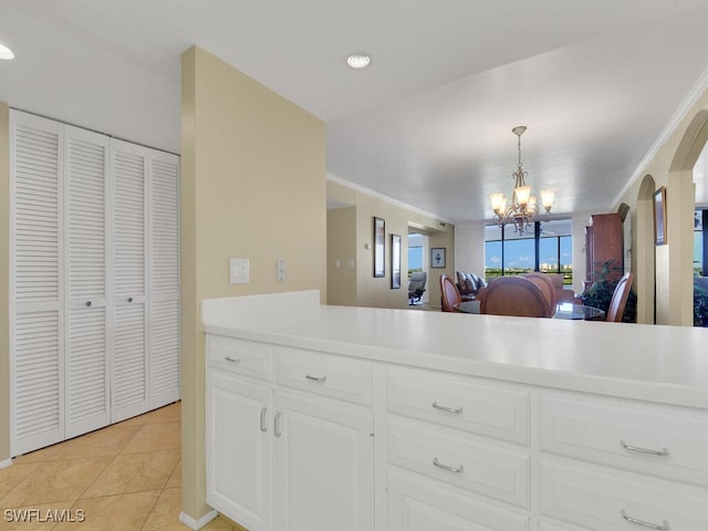 5260 S Landings Dr Unit 805, Fort Myers, FL 33919 - kitchen featuring white cabinets, light tile patterned flooring, an inviting chandelier, light countertops, and arched walkways