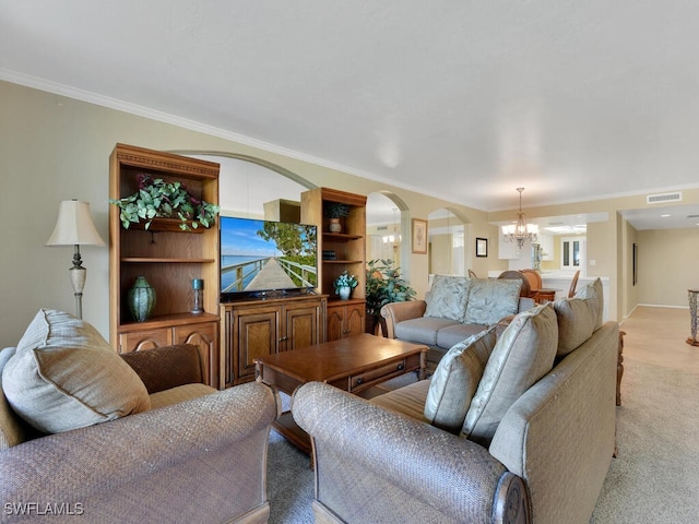 carpeted living room with ornamental molding and an inviting chandelier