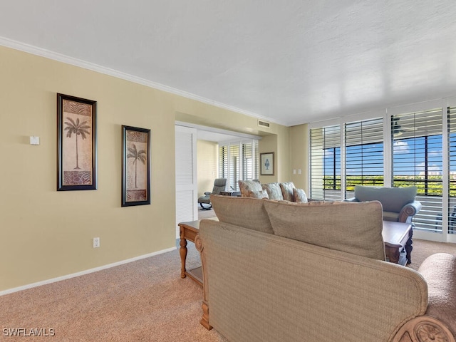 living room with crown molding, light colored carpet, and a wealth of natural light