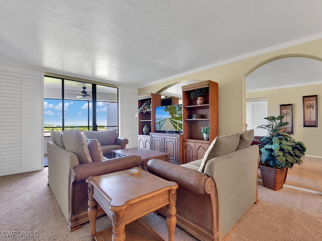 carpeted living room featuring crown molding, a textured ceiling, and ceiling fan