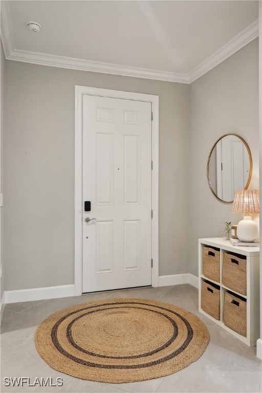 tiled foyer entrance with crown molding