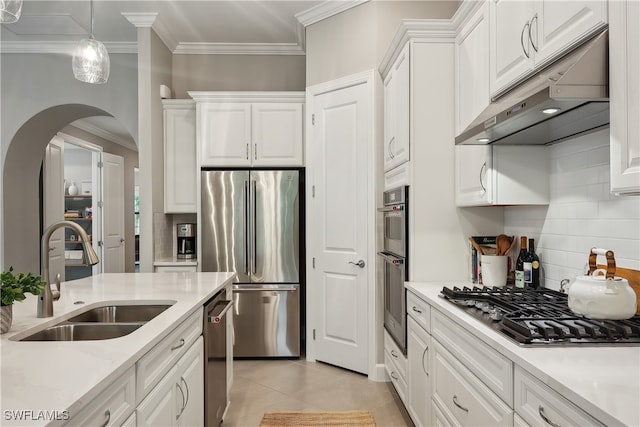 kitchen with stainless steel appliances, backsplash, white cabinets, and sink