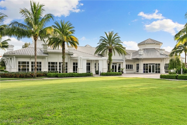 rear view of property with a lawn