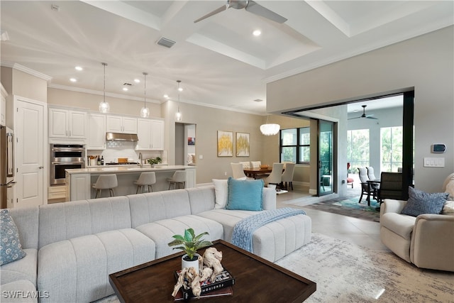 tiled living room featuring ornamental molding, coffered ceiling, ceiling fan, and beam ceiling